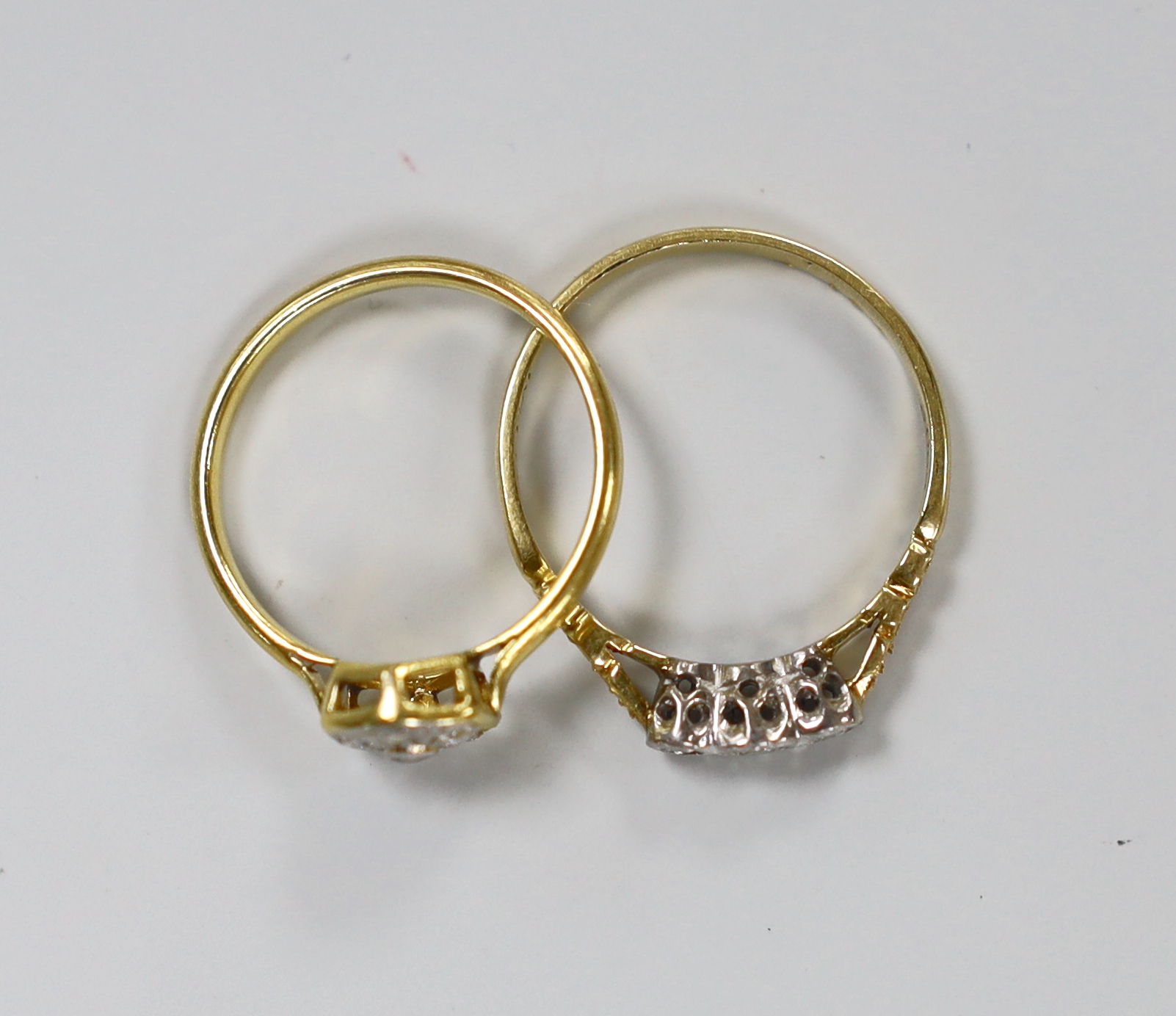 Two 18ct and diamond set rings including illusion set three stone and cluster(stone missing), gross weight 4.4 grams.